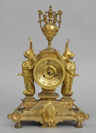 Appraisal: FRENCH GILT-BRONZE MANTEL CLOCK The dial with serpent-form pointers flanked