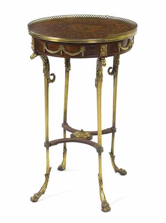 Appraisal: An Empire Style Marquetry and Gilt Metal Mounted Table having