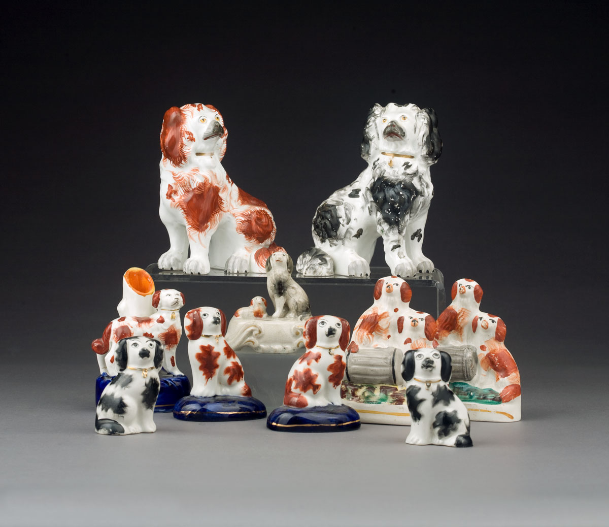 Appraisal: GROUP OF STAFFORDSHIRE POTTERY FIGURES OF SPANIELS MID-NINETEENTH TO EARLY