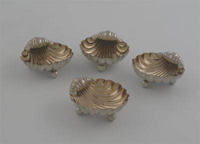 Appraisal: A set of four Victorian shell salts gilt interior on