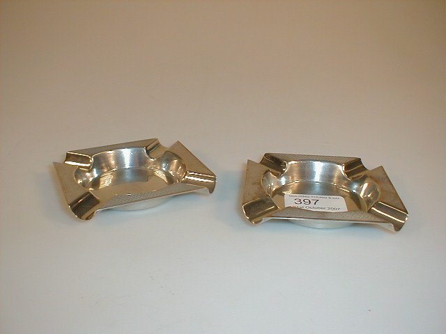 Appraisal: A pair of silver engine turned ashtrays Maker E V