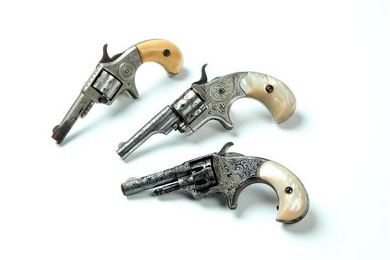 Appraisal: THREE ENGRAVED CALIBER REVOLVERS America late th century A Colt