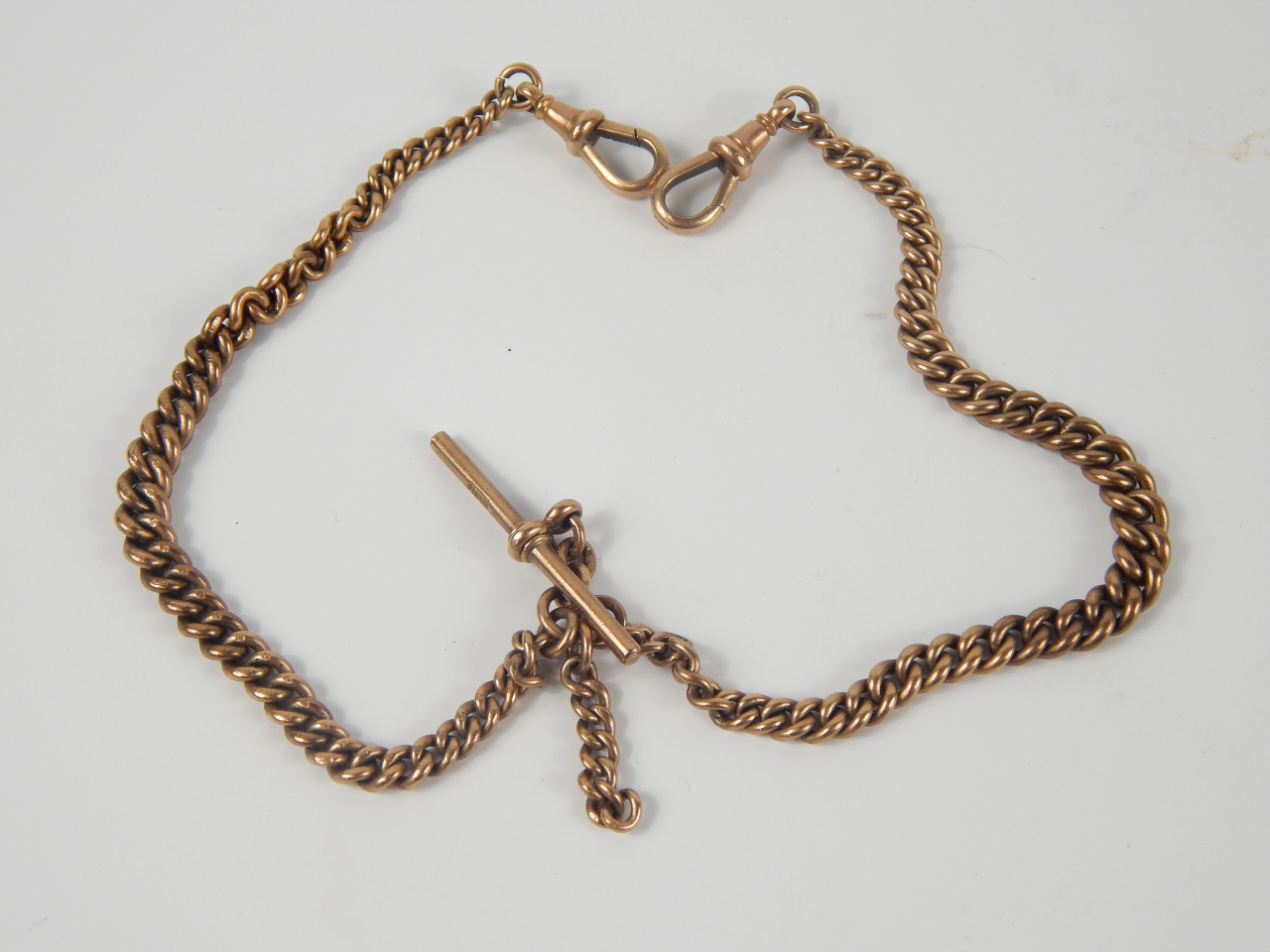 Appraisal: A ct gold curb link Albert chain with two snap