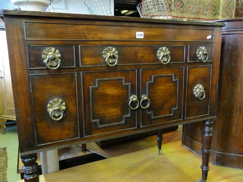 Appraisal: A th century mahogany side cupboard on turned supports fitted