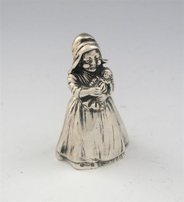 Appraisal: A German figural bell modelled as a peasant girl in