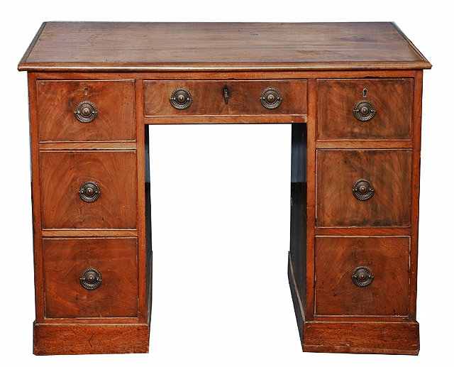 Appraisal: A GEORGE III MAHOGANY KNEEHOLE WRITING DESK fitted a central