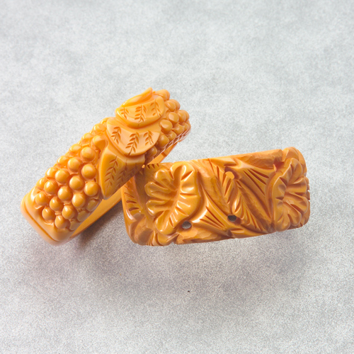 Appraisal: Two Bakelite tan clamper bracelets deeply carved with bead and