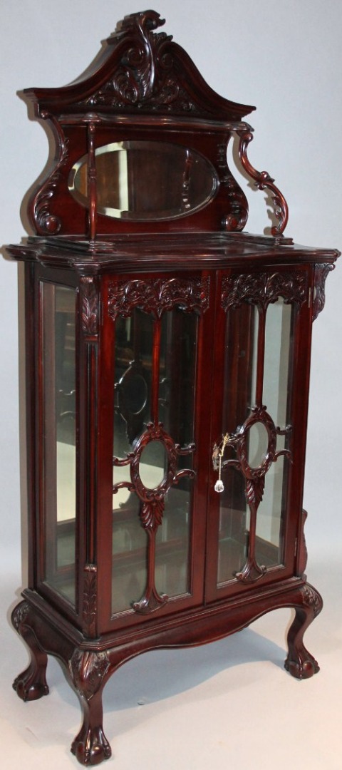 Appraisal: A highly elaborate Edwardian stained display cabinet the heavily carved