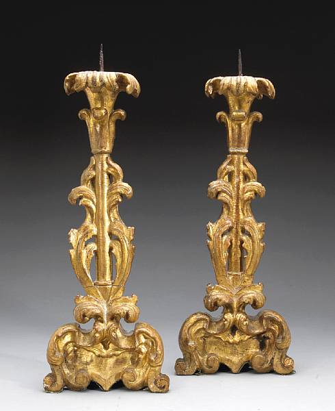 Appraisal: A pair of Italian Baroque giltwood prickets th century Each