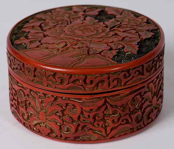 Appraisal: Cinnabar Box Chinese a cinnabar lidded box with peonies carved