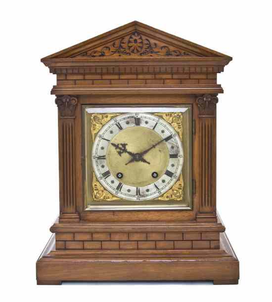 Appraisal: An English Oak Mantel Clock of peaked form the circular