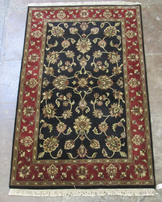 Appraisal: HAND KNOTTED ORIENTAL AREA RUG Persian Isfahan design on black