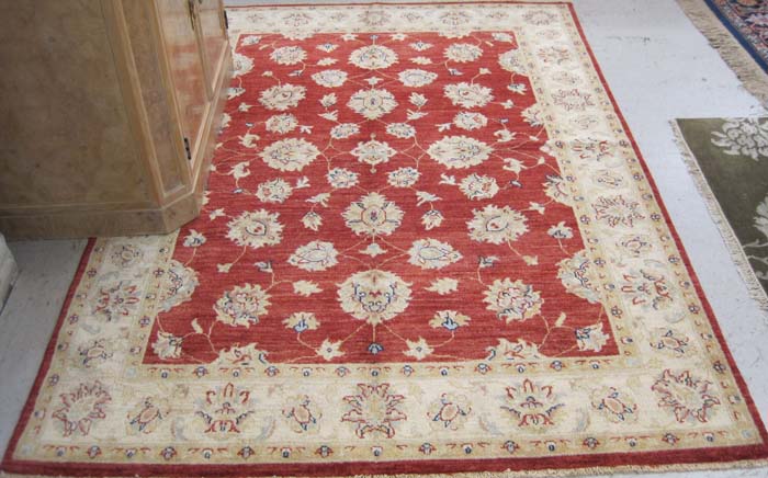 Appraisal: HAND KNOTTED ORIENTAL AREA RUG Pakistani-Persian overall floral arabesque pattern