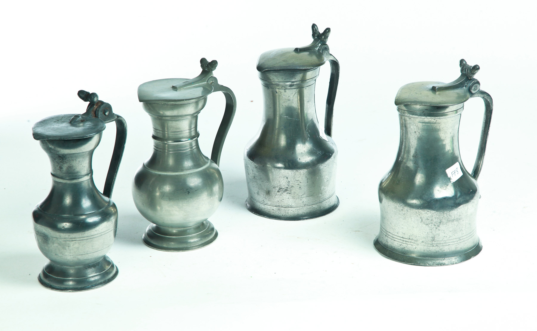 Appraisal: FOUR FRENCH PEWTER FLAGONS Nineteenth century Similar forms with acorn-shaped