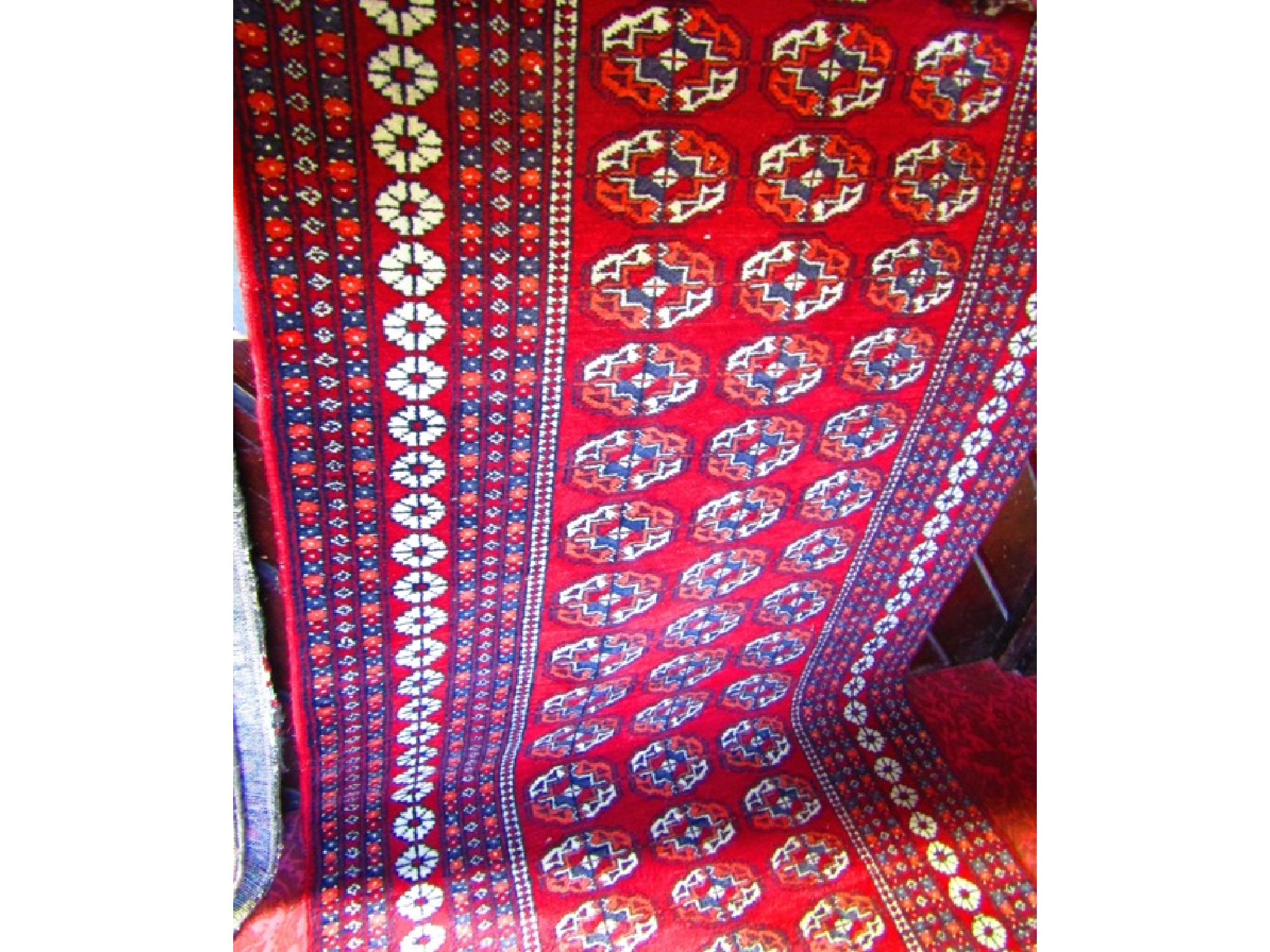 Appraisal: An Persian style deep red ground wool runner the central