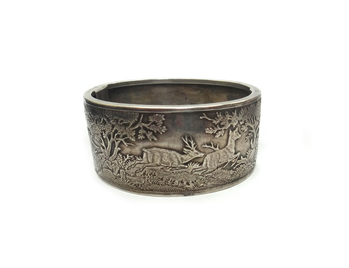 Appraisal: An early th century white metal broad hinged bangle engraved