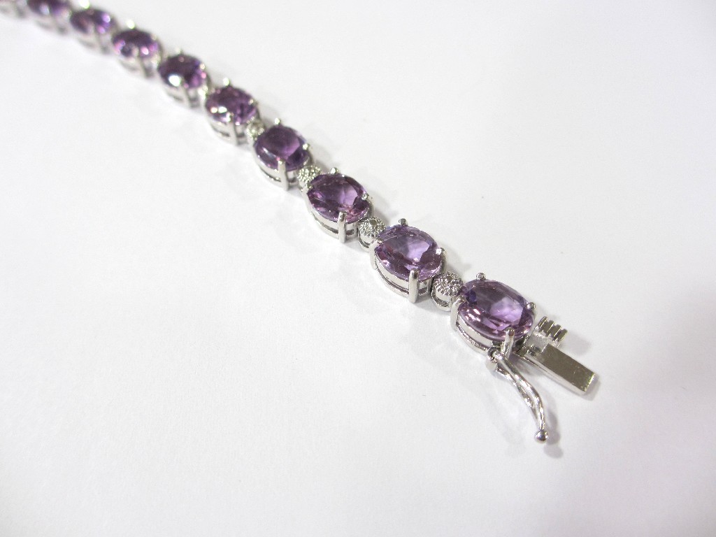 Appraisal: A silver and amethyst bracelet the articulated links set with