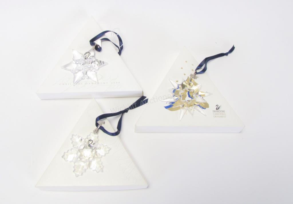 Appraisal: Three Swarovski crystal annual ornaments including snowflake snowflake and snowflake