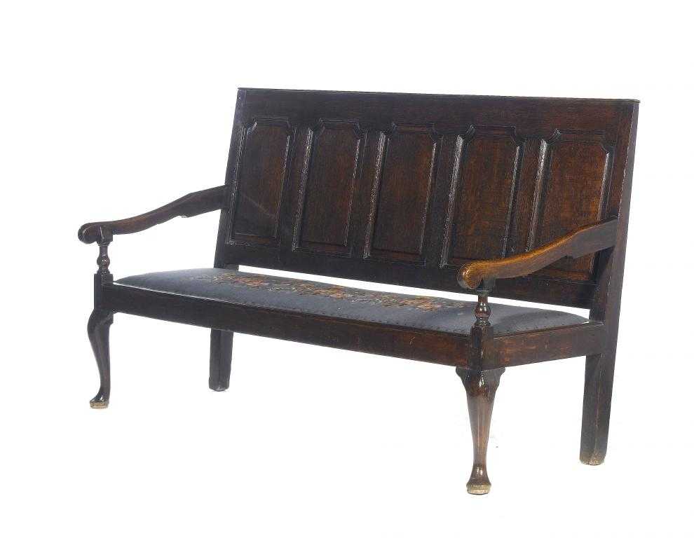 Appraisal: A GEORGE III OAK SETTLE the raked back with five