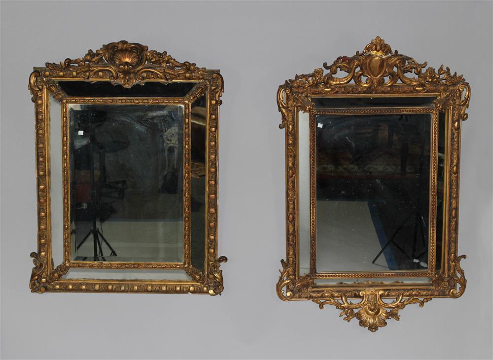 Appraisal: TWO SIMILAR ROCOCO STYLE GILTWOOD MIRRORS having a pierced carved