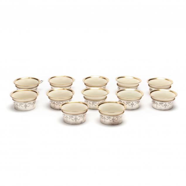 Appraisal: AMERICAN STERLING SILVER AND PORCELAIN RAMEKIN SET OF TWELVE Mark