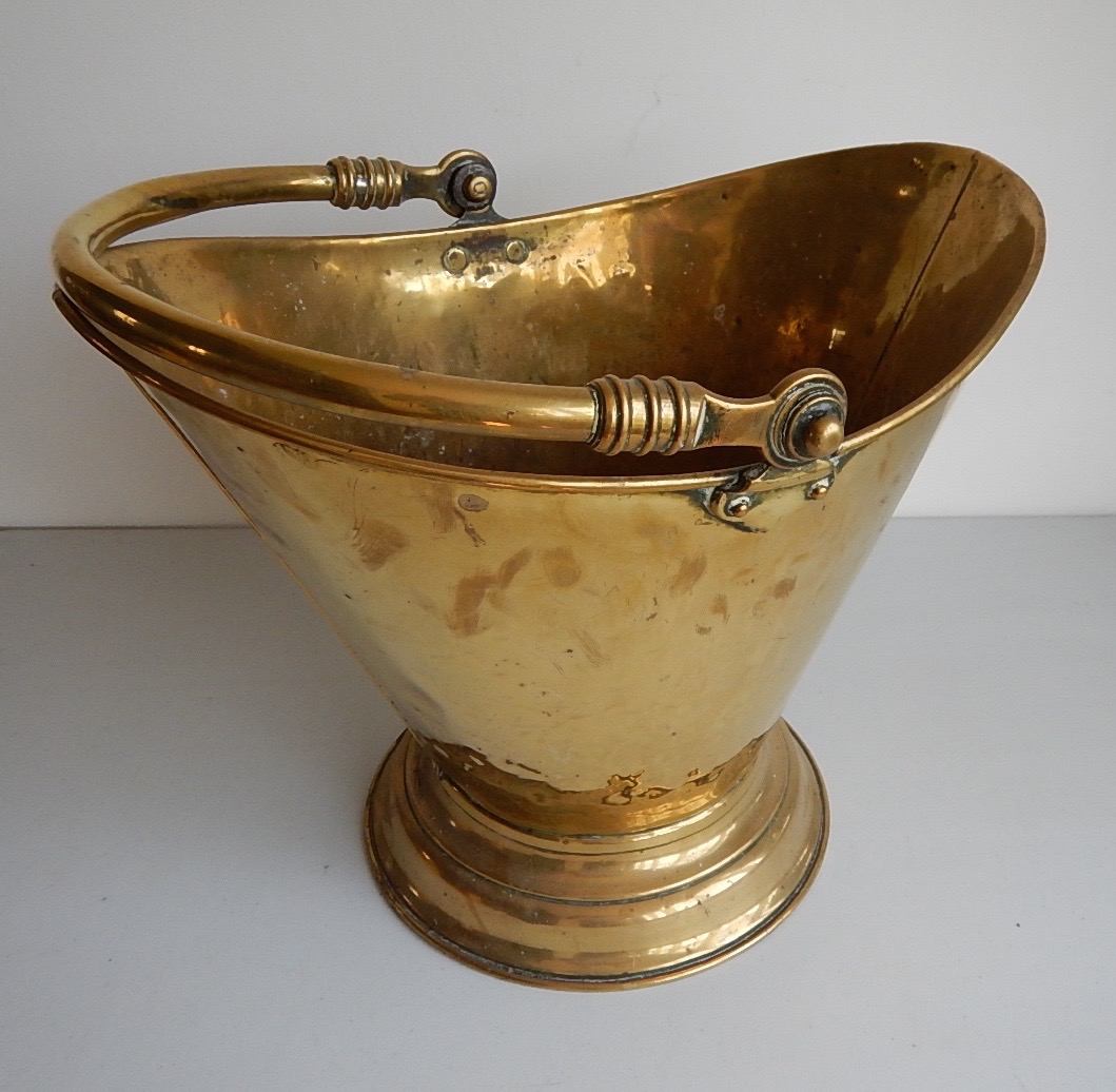 Appraisal: A brass tapered coal bucket with swing handle