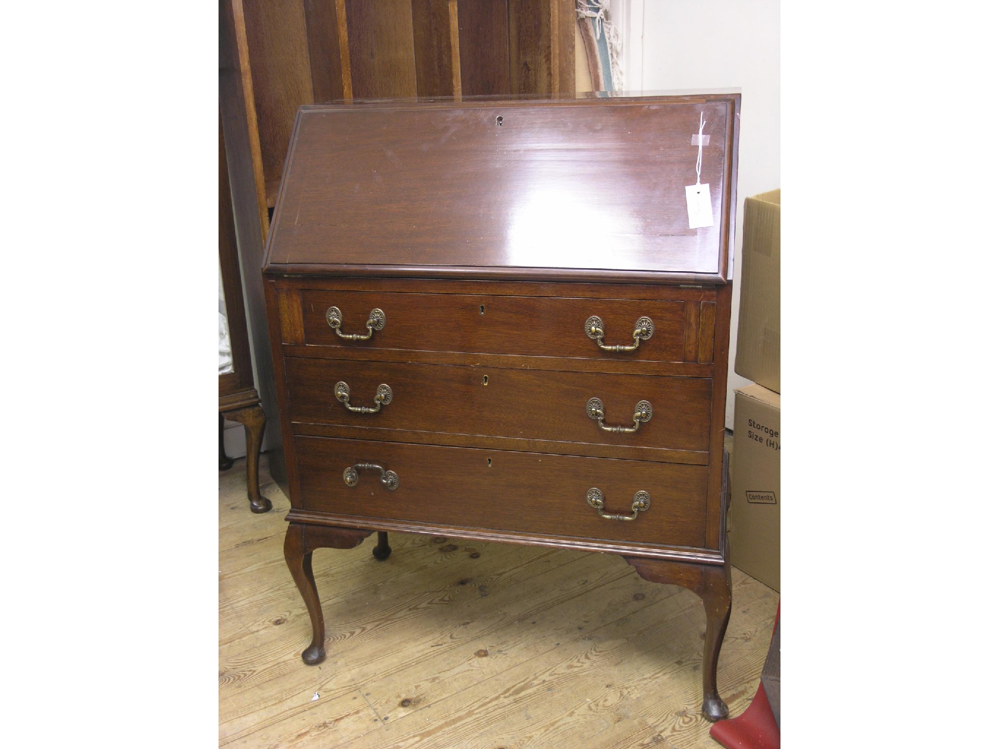 Appraisal: A mahogany bureau fall-front enclosing fittings above three long drawers