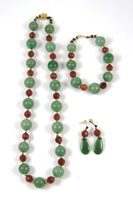 Appraisal: FOUR PIECE GREEN JADE AND RUBY JEWELRY SET including an