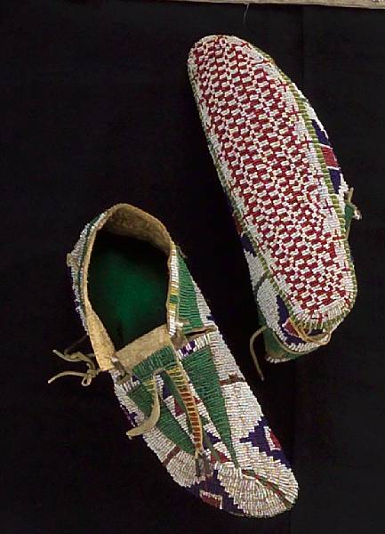 Appraisal: A pair of Sioux beaded ceremonial moccasins Fully beaded on