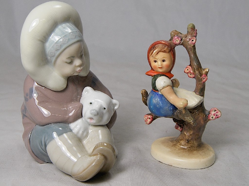 Appraisal: Lladro figure of Eskimo hugging polar bear cub to w