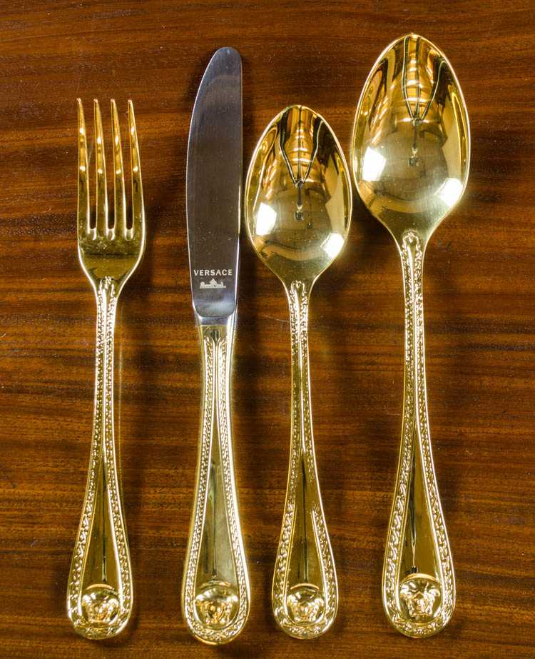 Appraisal: ROSENTHAL FOR VERSACE MEDUSA GOLD FLATWARE thirty-six piece service for