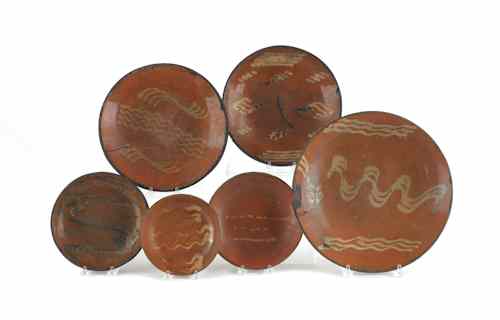 Appraisal: Six Pennsylvania redware plates and chargers th c with yellow