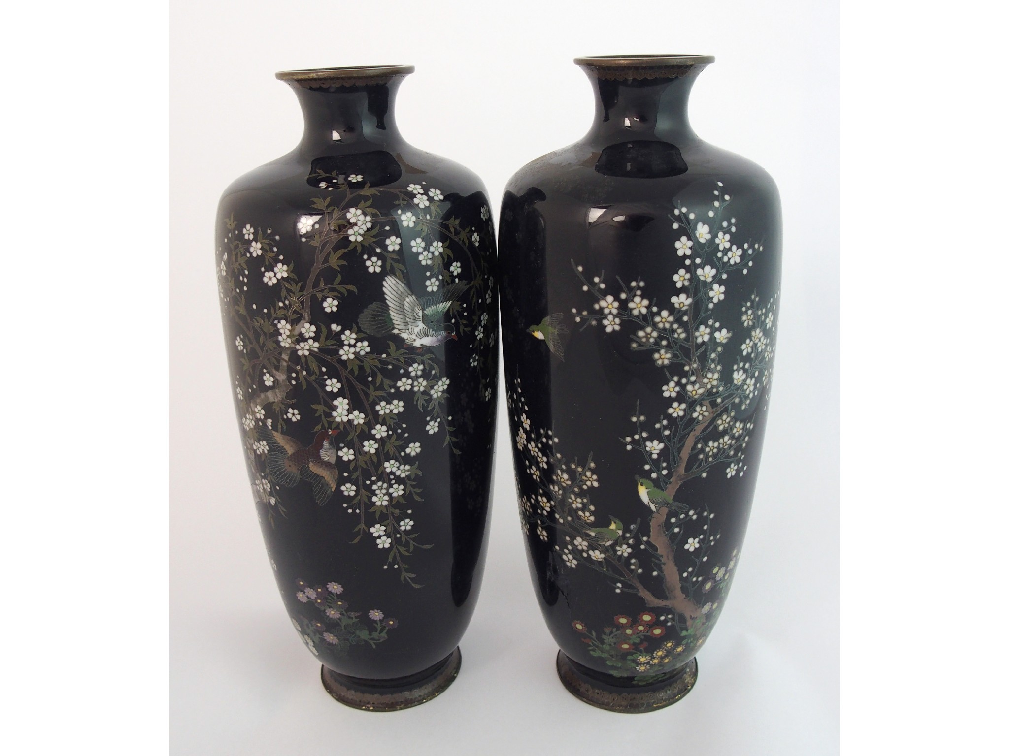 Appraisal: A pair of Japanese cloisonne baluster vasesdecorated with doves amongst