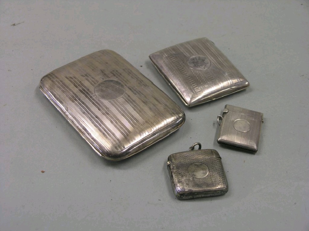 Appraisal: An engine turned silver cigar case Birmingham together with one