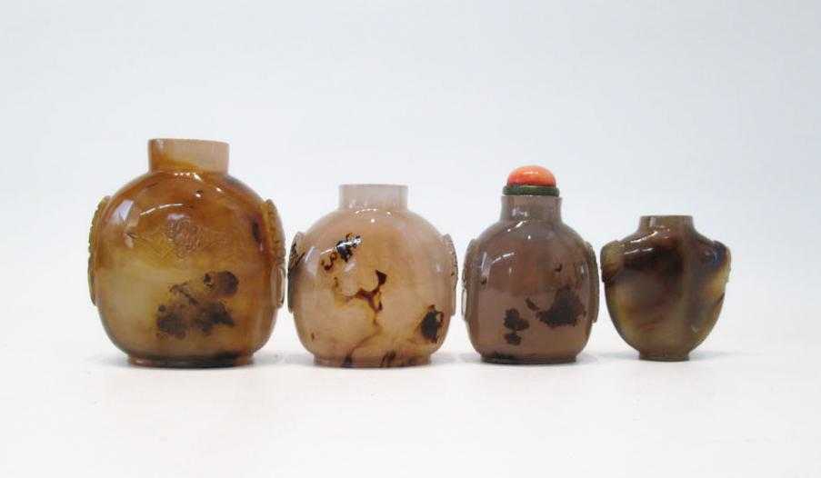 Appraisal: FOUR CHINESE CARVED AGATE SNUFF BOTTLES of compressed form and