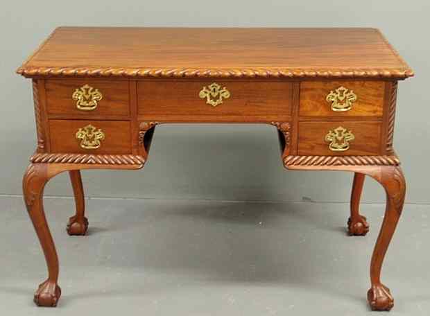 Appraisal: Chippendale style mahogany desk with an ornately carved rectangular top