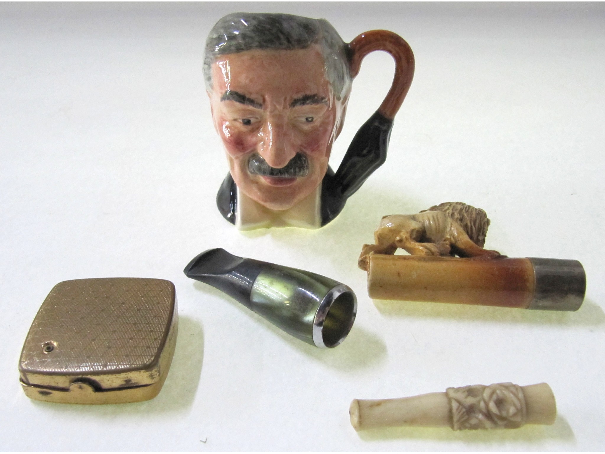 Appraisal: A lot comprising a small character jug cigar and cigarette