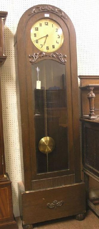 Appraisal: A 's dark oak veneered longcase clock with circular brass