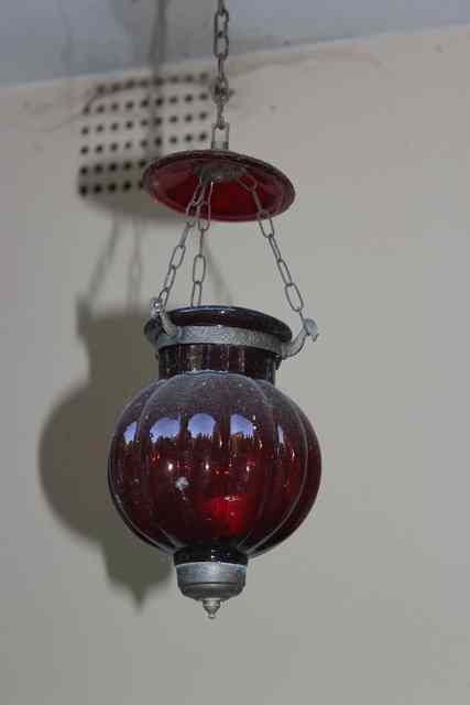 Appraisal: A SET OF EIGHT SPHERICAL RED GLASS HANGING CANDLE LANTERNS