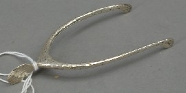 Appraisal: A pair of sterling silver tongs modelled as a wishbone