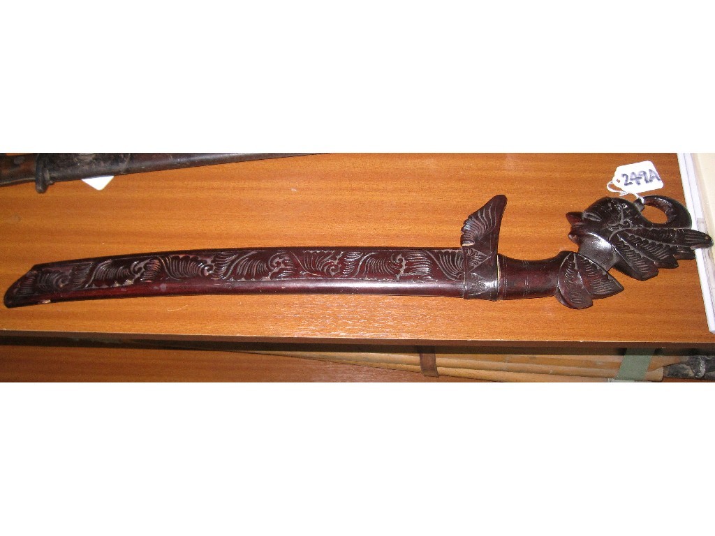 Appraisal: Indonesian short sword with hilt carved as a man in