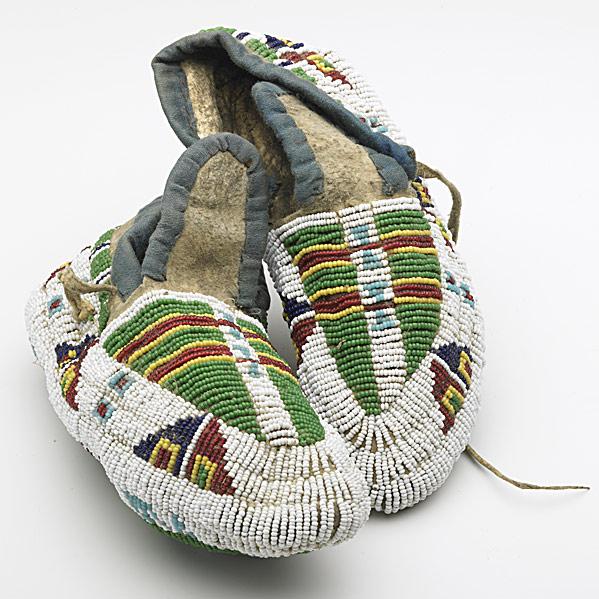 Appraisal: SIOUX CHILD S FULLY BEADED MOCCASINSSinew-sewn on hide accented with