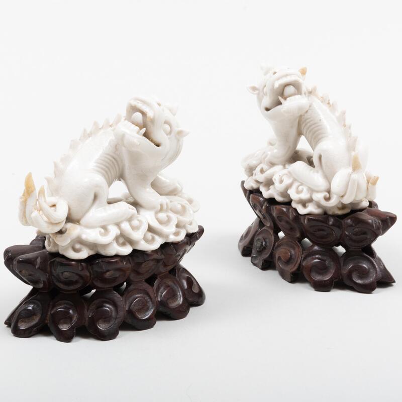 Appraisal: Pair of Chinese White Glazed Porcelain Mythical Beasts On wood