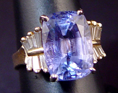 Appraisal: CT TANZANITE RING WITH DIAMONDS K yellow gold ring centering