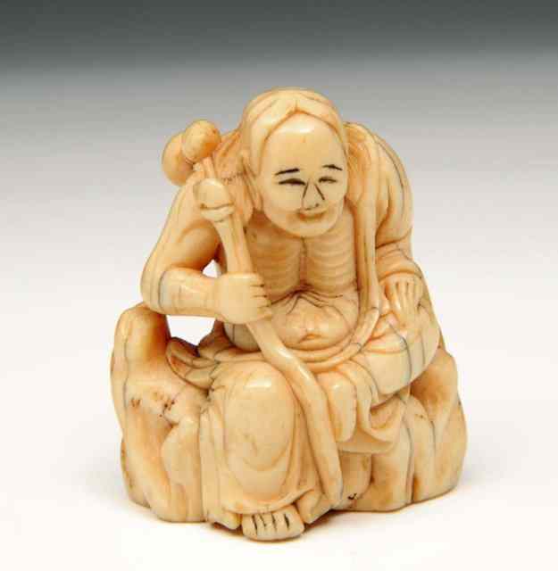 Appraisal: AN IVORY RAKAN NETSUKE the figure with gourds seated on