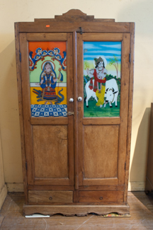 Appraisal: AN INDIAN PAINTED GLASS FRONT CABINET