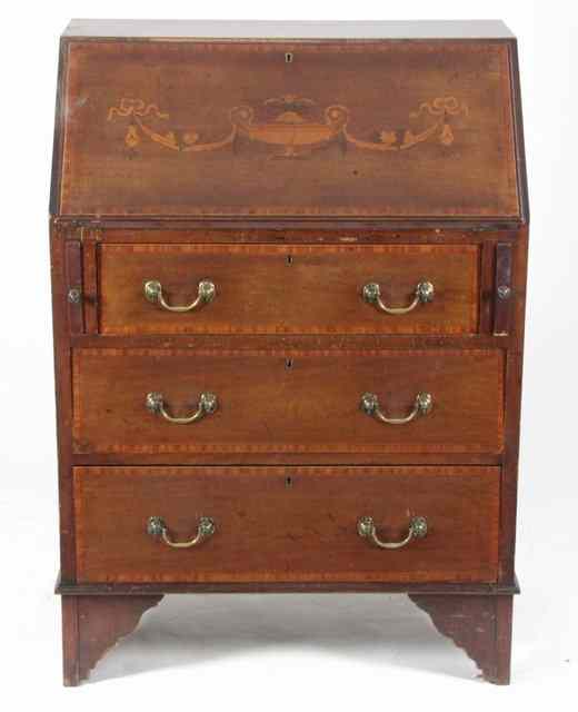 Appraisal: An Edwardian mahogany bureau the fall enclosing a fitted interior