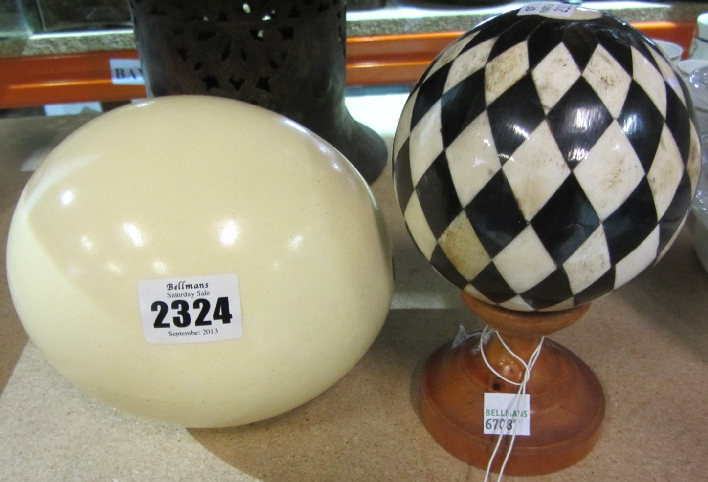 Appraisal: An Ostrich egg a carpet bowl a wooden stand and