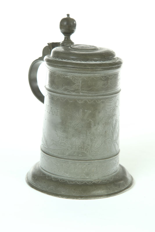 Appraisal: ENGRAVED PEWTER TANKARD European th century Landscape done in wriggle