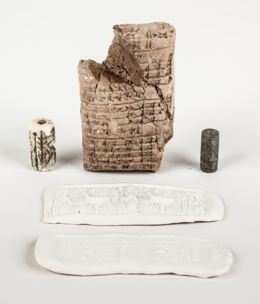 Appraisal: Two Mesopotamian cylinder seals and a tablet comprising a gray